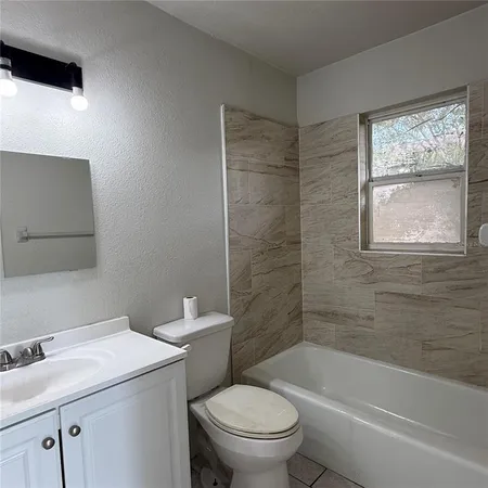 a bathroom with a sink a toilet and a bathtub