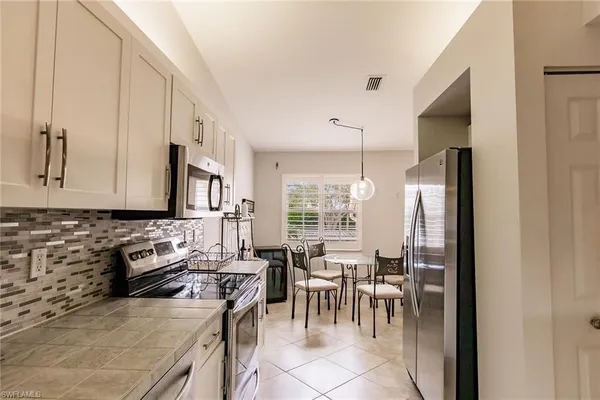 a kitchen with stainless steel appliances granite countertop a sink stove and microwave