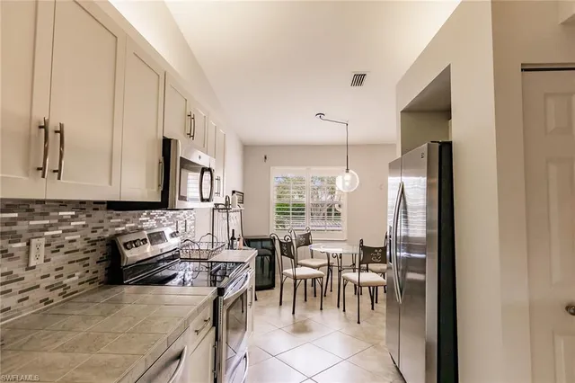 a kitchen with stainless steel appliances granite countertop a sink stove and microwave