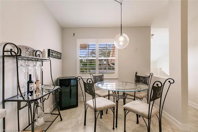 a view of a dining room with furniture and a window