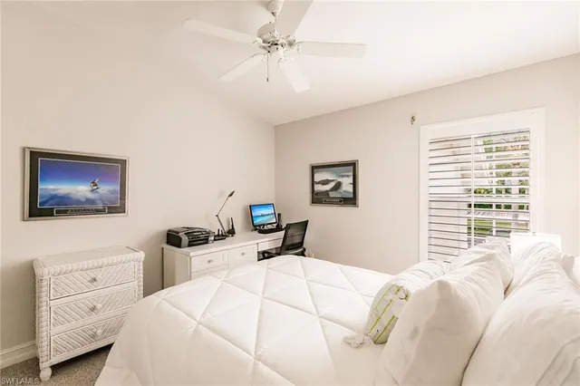 a bedroom with a bed and a table