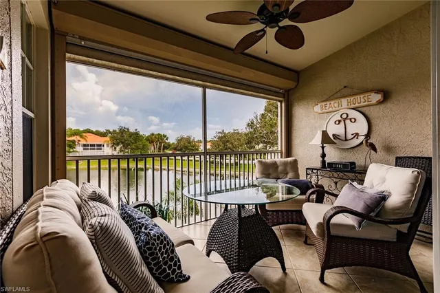a balcony view with a couch and large windows