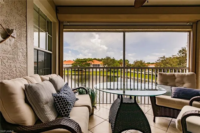 a balcony with furniture and a potted plant
