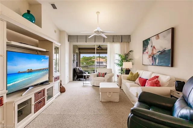 a living room with furniture flowerpot and a chandelier