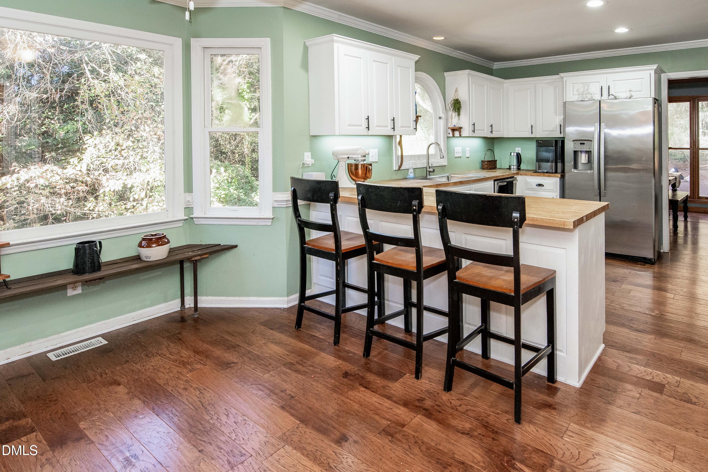 123 Chris Court Garner, NC 27529 - Photo 11 of 24 a view of a dining room with furniture window and wooden floor