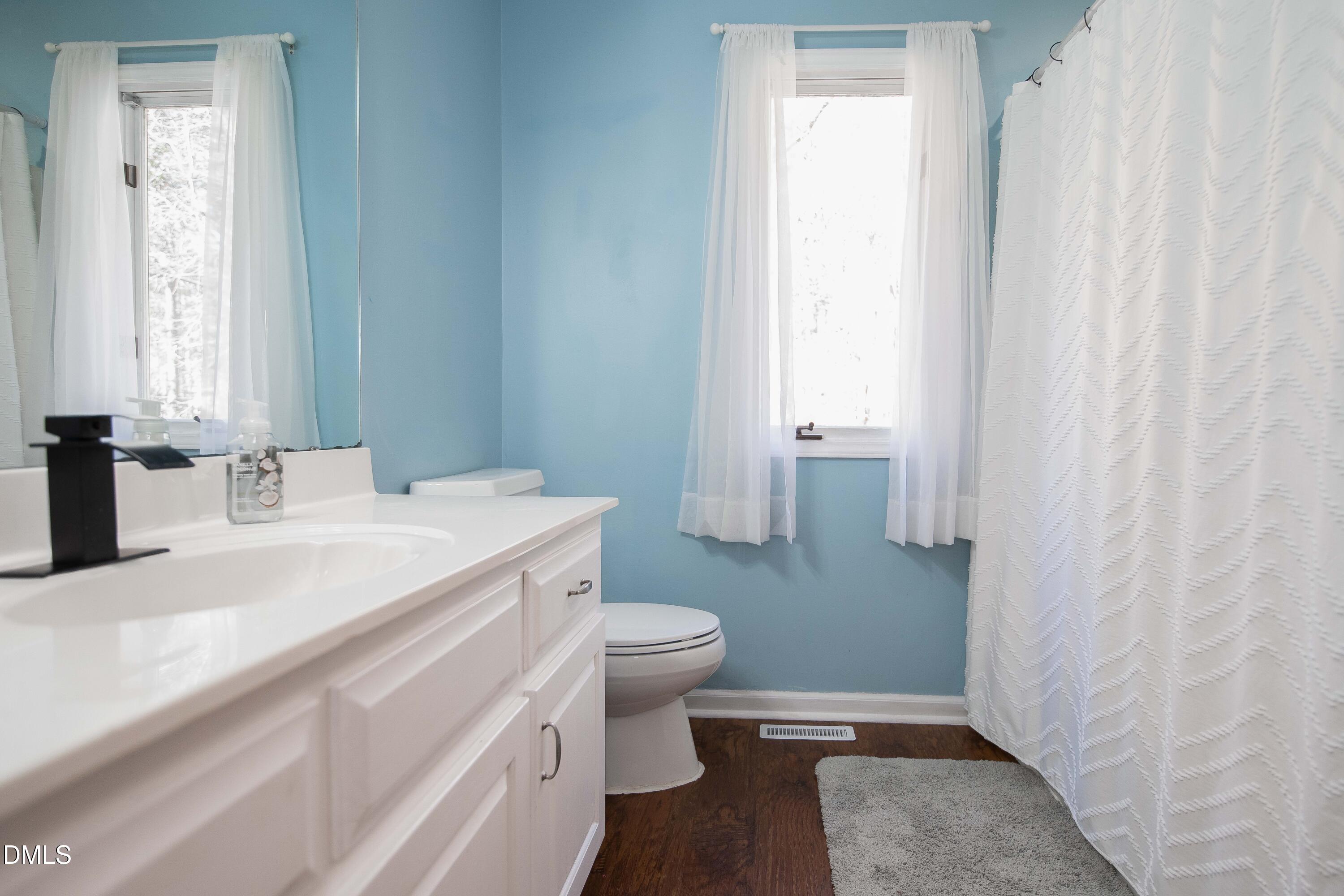 123 Chris Court Garner, NC 27529 - Photo 13 of 24 a bathroom with a sink toilet and window