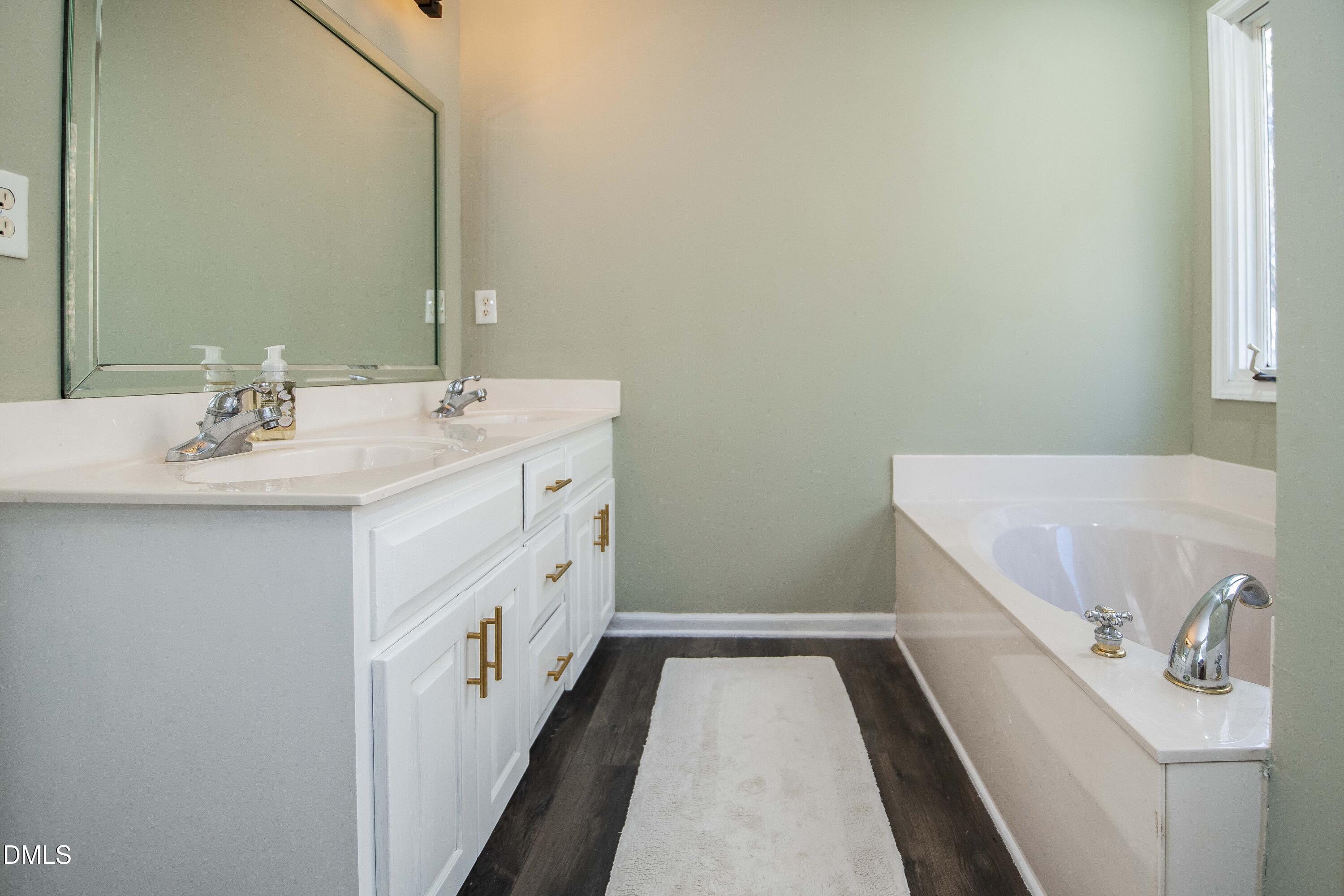 123 Chris Court Garner, NC 27529 - Photo 17 of 24 a bathroom with a sink and a mirror