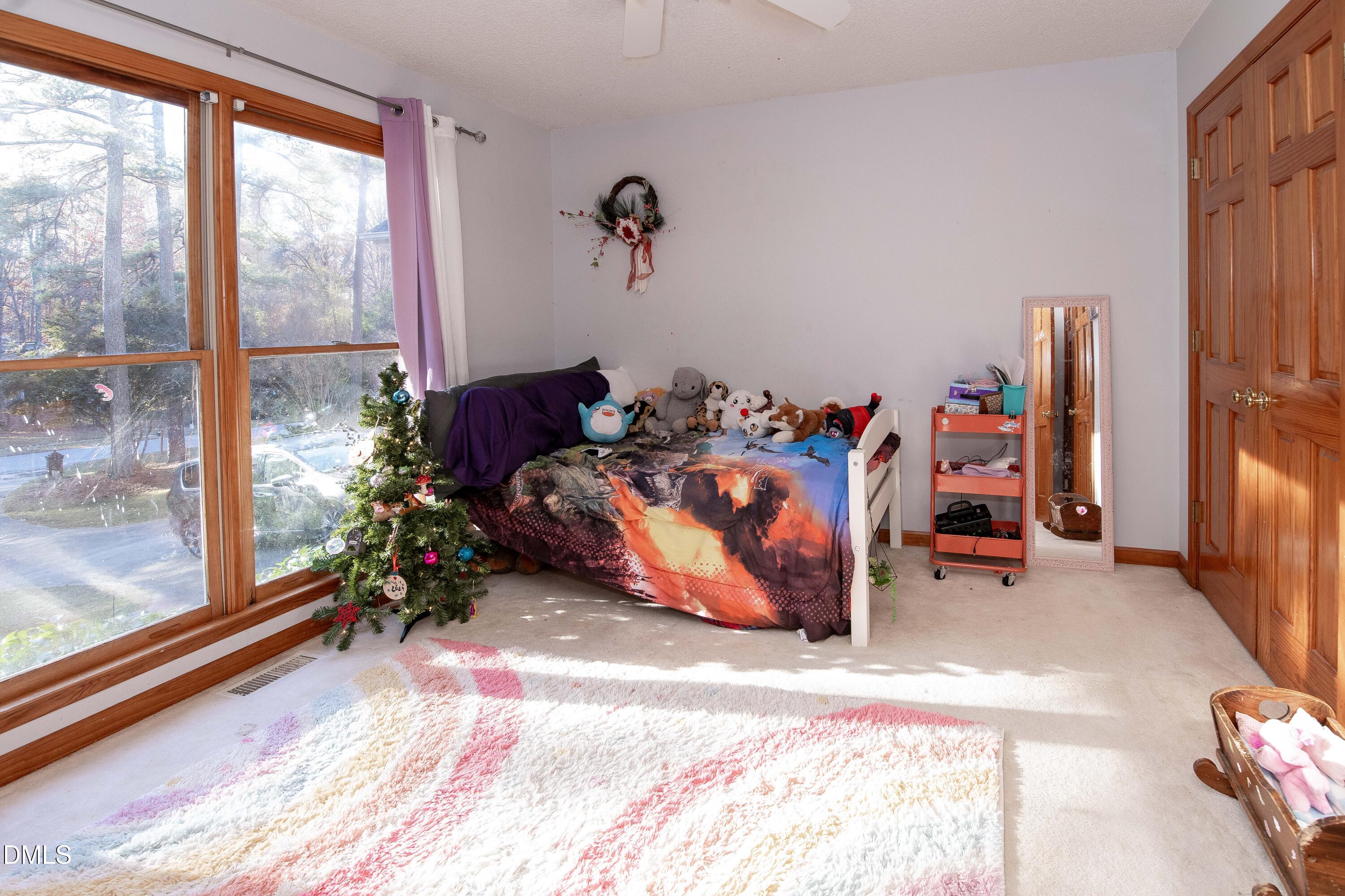 123 Chris Court Garner, NC 27529 - Photo 20 of 24 a bed room with a bed and a window