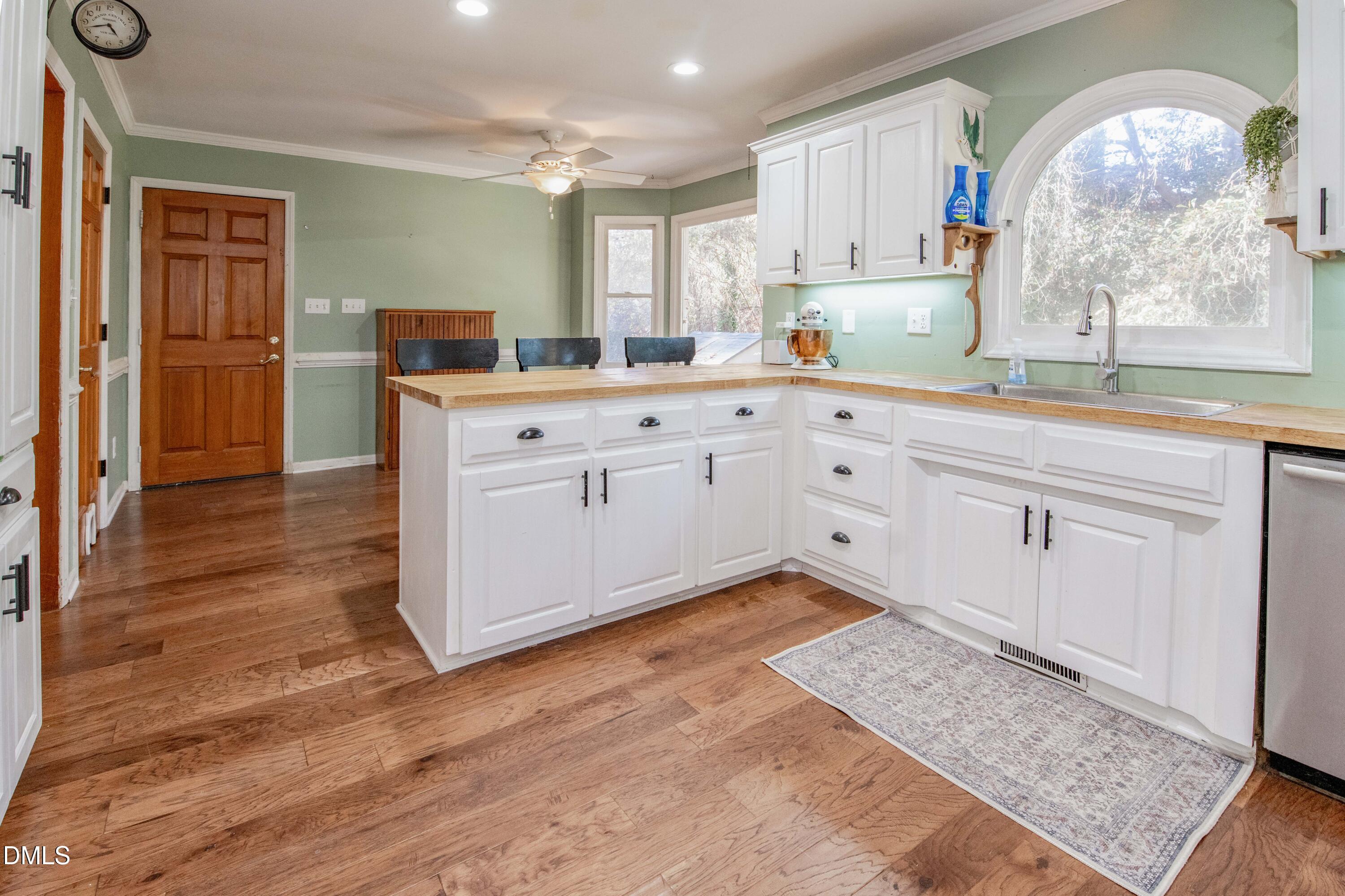 123 Chris Court Garner, NC 27529 - Photo 8 of 24 a kitchen with white cabinets and sink
