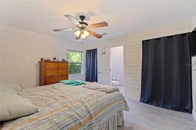 a bedroom with a bed and a closet