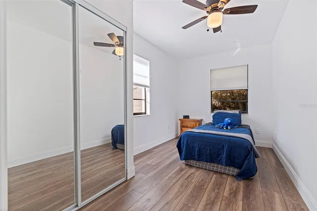 a bedroom with a bed and wooden floor