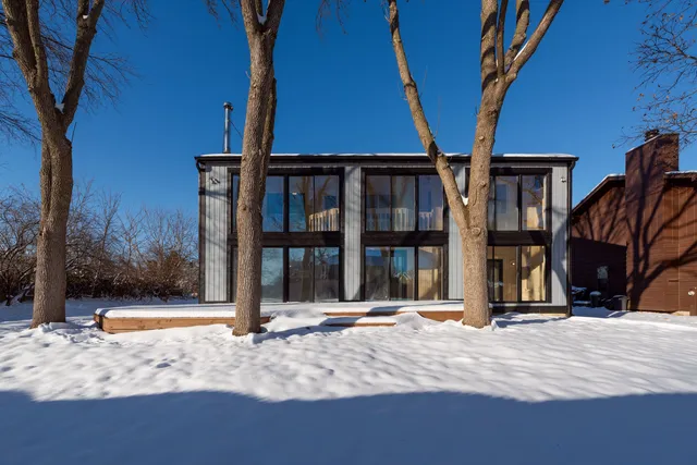 a view of a house with a tree in the background