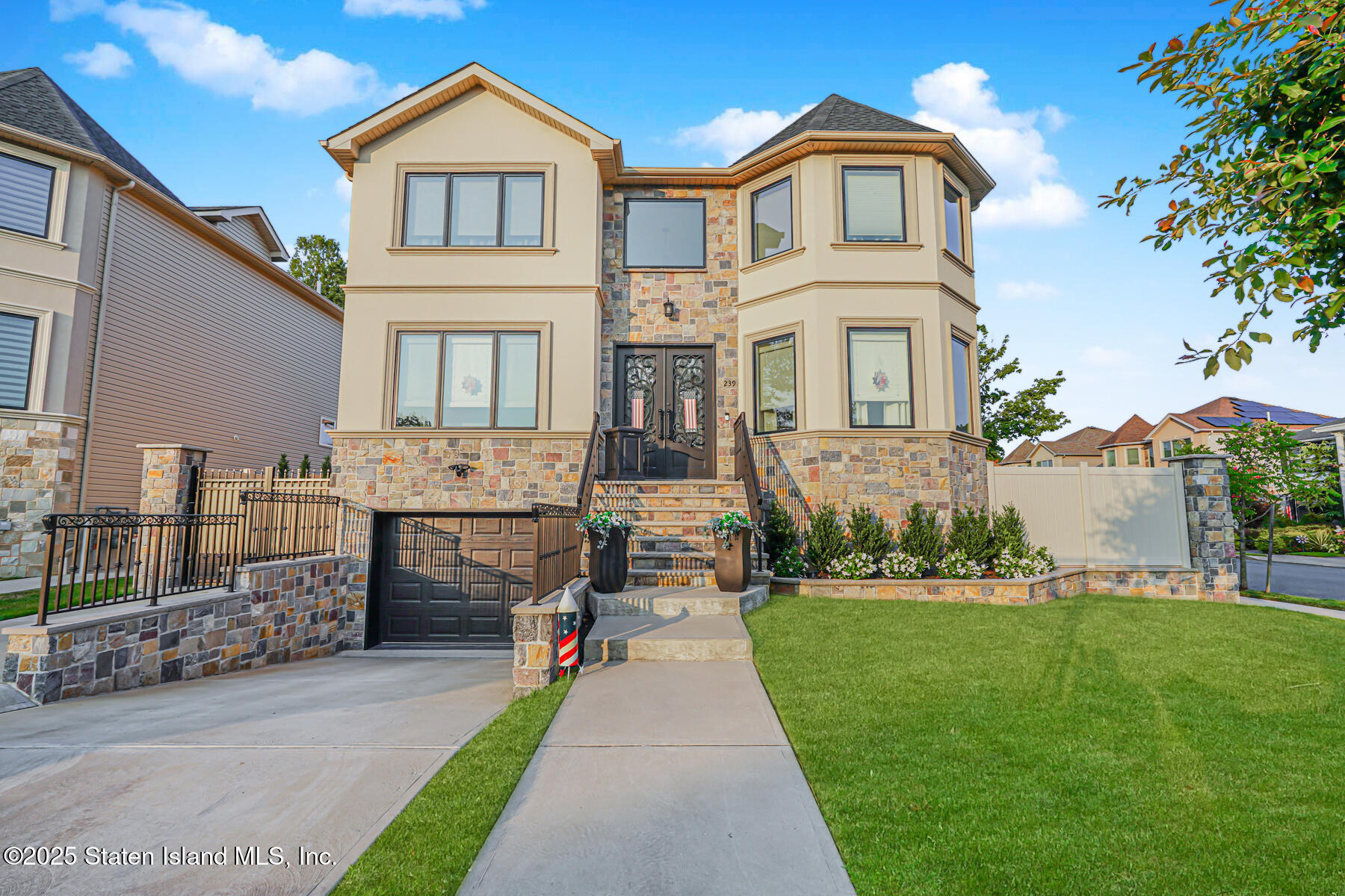 a front view of a house with a garden and yard