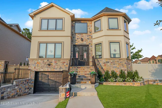 a front view of a house with a garden