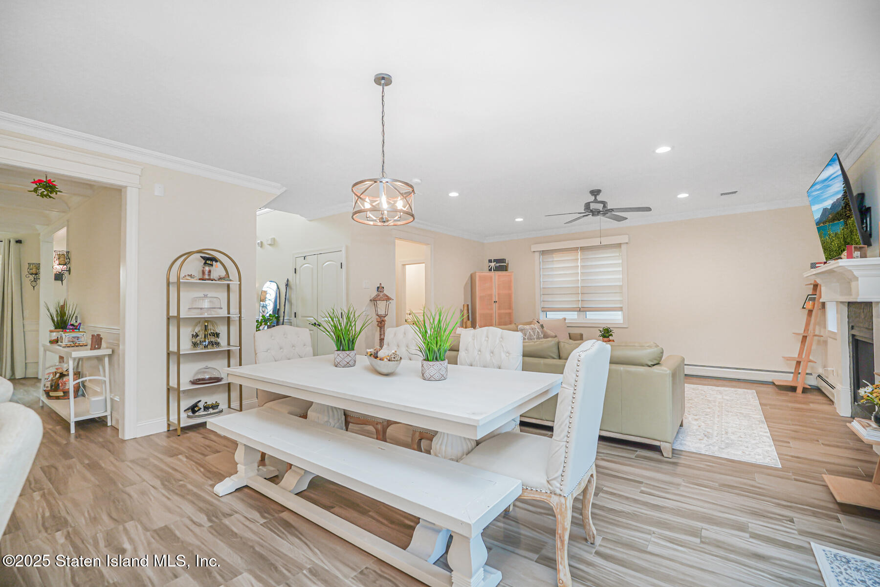 239 Vernon Avenue Staten Island, NY 10309 - Photo 24 of 67 a view of a dining room and livingroom with furniture wooden floor a chandelier