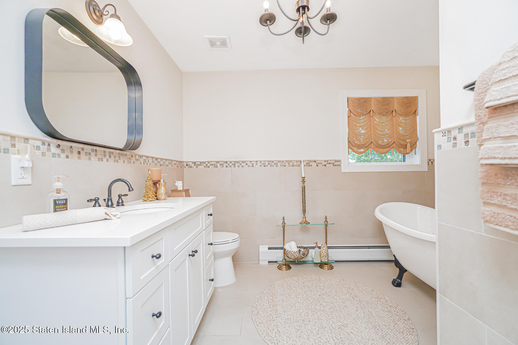 239 Vernon Avenue Staten Island, NY 10309 - Photo 38 of 67 a bathroom with a sink mirror and a toilet