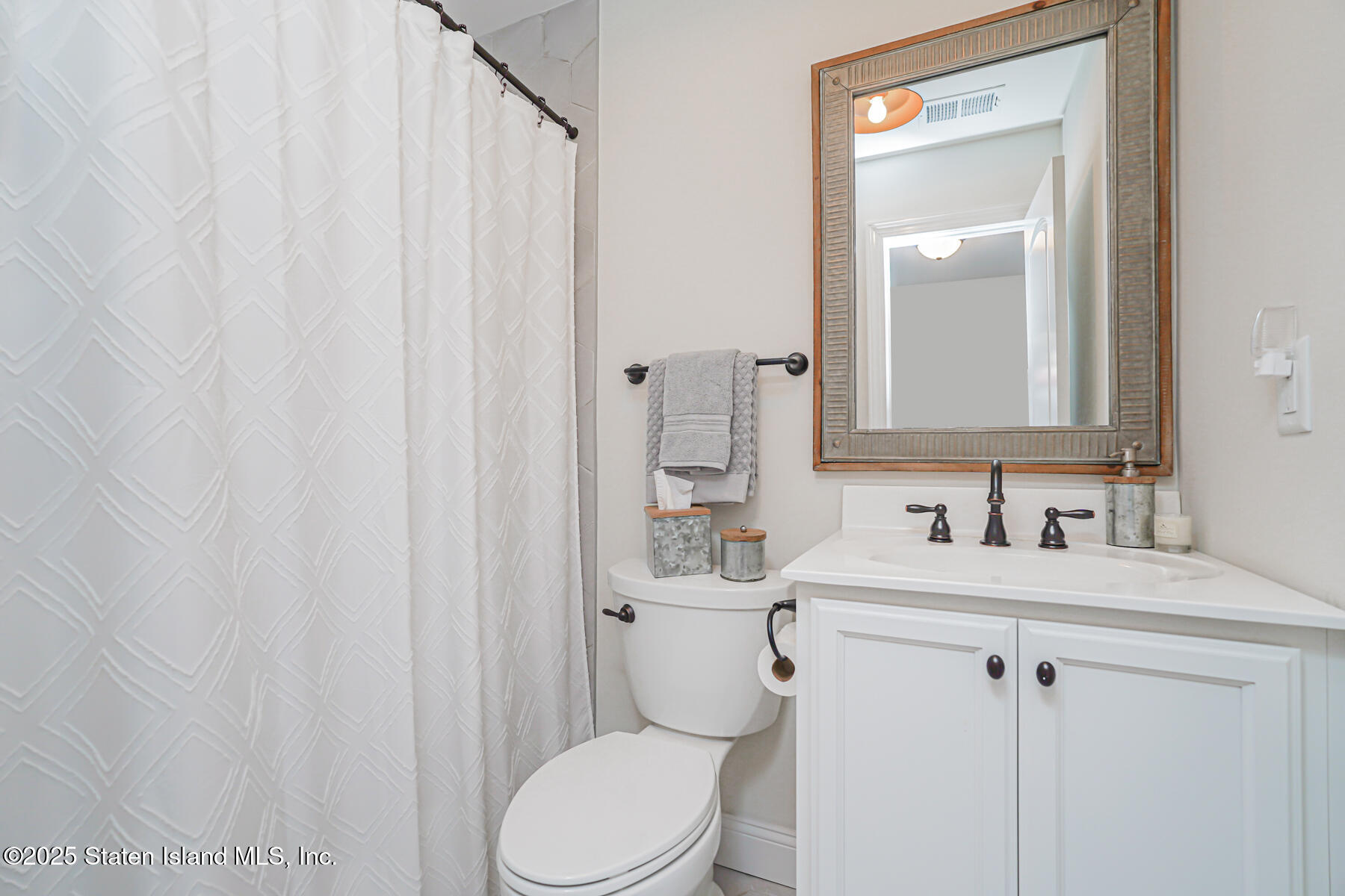 239 Vernon Avenue Staten Island, NY 10309 - Photo 50 of 67 a bathroom with a sink a toilet and shower