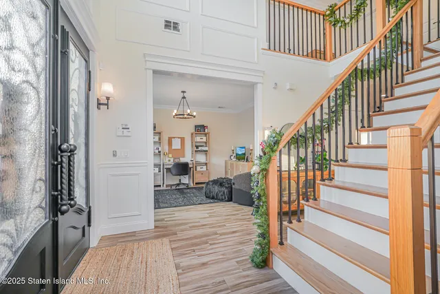 a view of a dining room with furniture wooden floor and chandelier