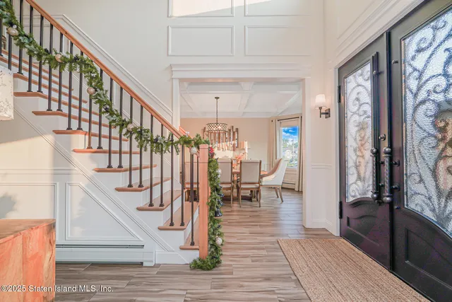 a view of a dining room with furniture wooden floor and chandelier