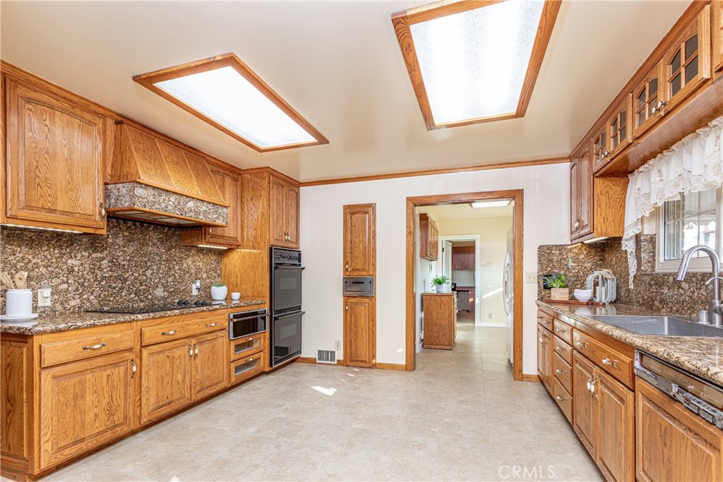 590 Bethany Road Burbank, CA 91504 - Photo 20 of 58 a kitchen with stainless steel appliances granite countertop a stove a sink and a refrigerator