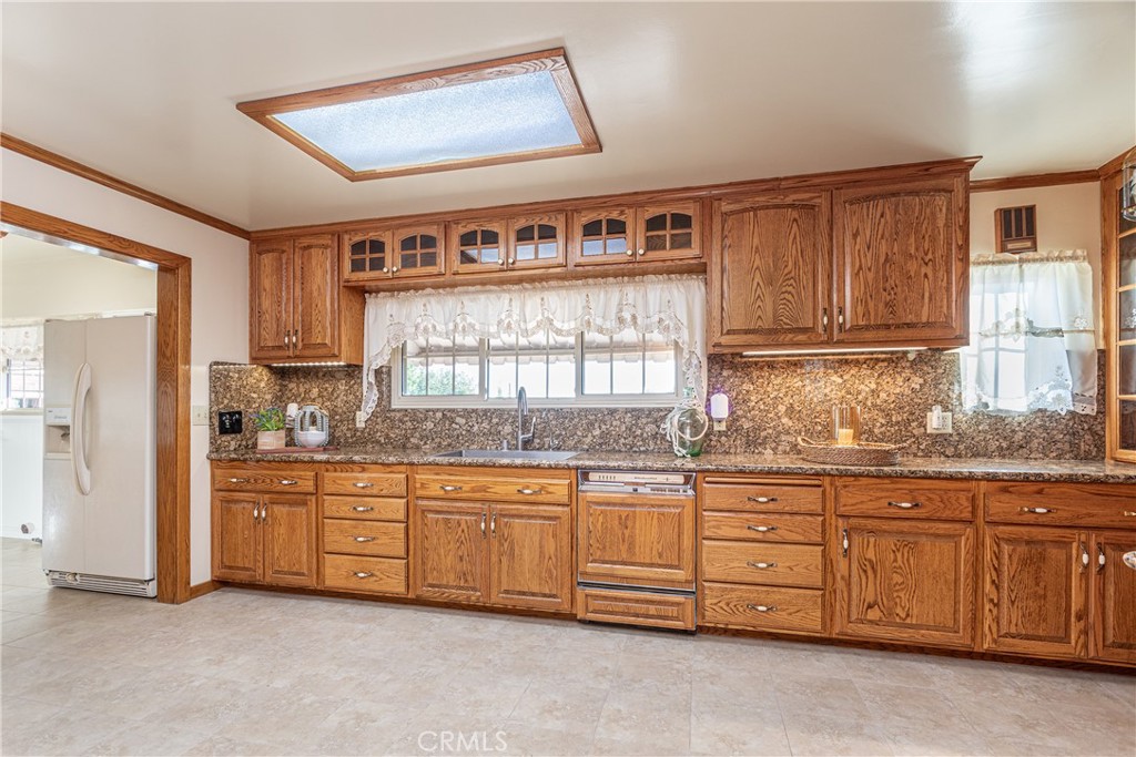 590 Bethany Road Burbank, CA 91504 - Photo 22 of 58 a kitchen with granite countertop a stove a sink and a refrigerator