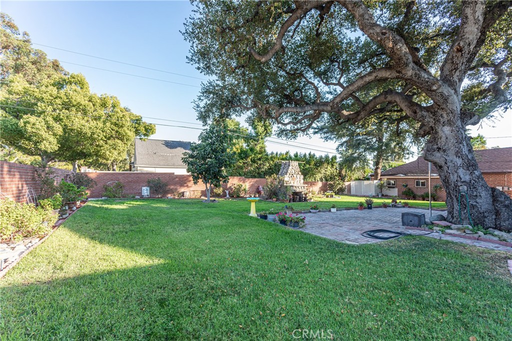 590 Bethany Road Burbank, CA 91504 - Photo 43 of 58 a view of a backyard with table and chairs and a large tree