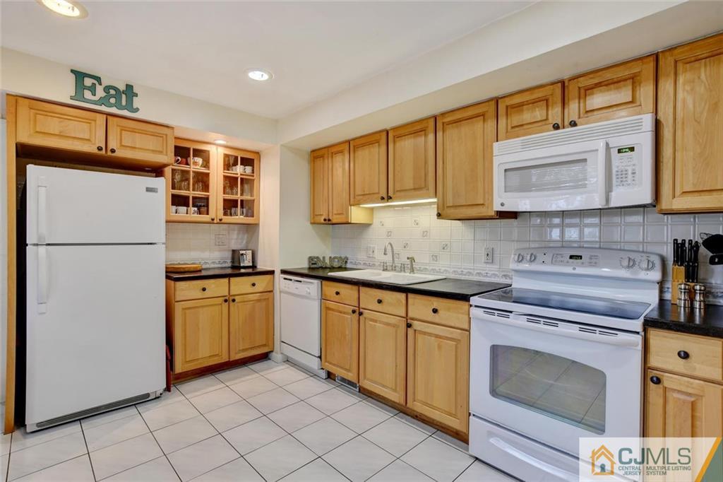 14 Drake Road Somerset, NJ 08873 - Photo 11 of 25 a kitchen with stainless steel appliances granite countertop a refrigerator sink stove and microwave