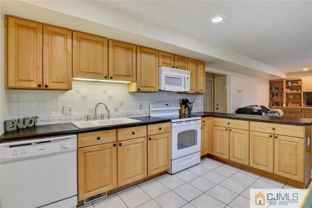 14 Drake Road Somerset, NJ 08873 - Photo 10 of 25 a kitchen with granite countertop white cabinets sink and stainless steel appliances