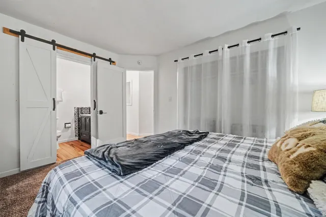 a bathroom with a granite countertop toilet sink and mirror