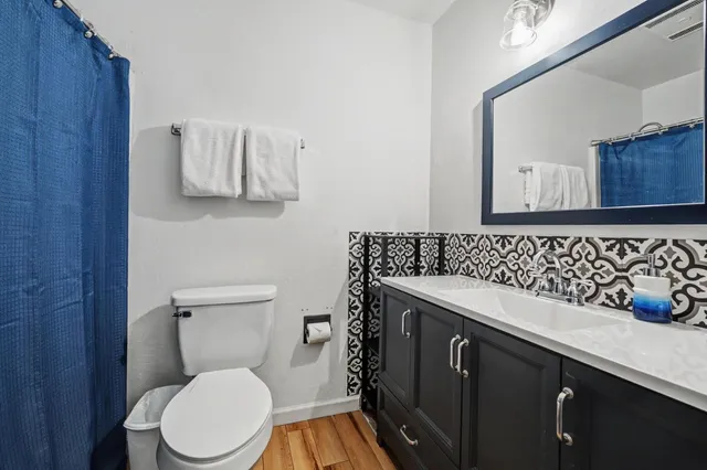 a bedroom with a bed and a painting on the wall