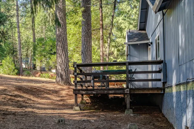 a balcony with wooden floor and outdoor seating