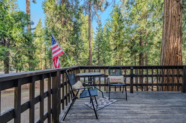 a view of a house with a balcony and trees
