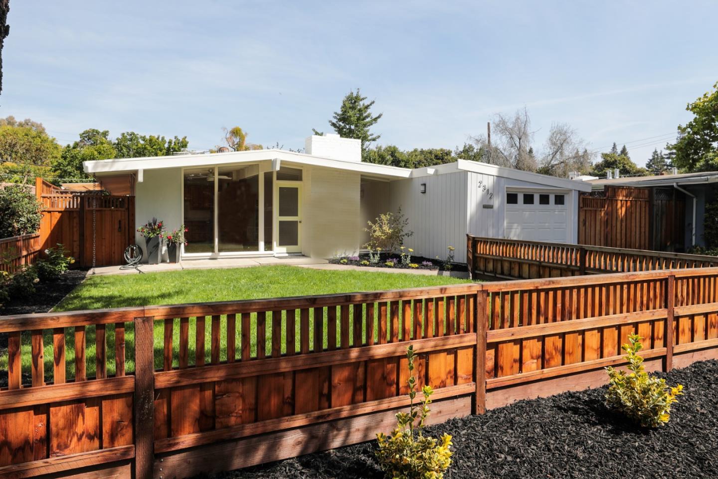 a view of a house with wooden deck