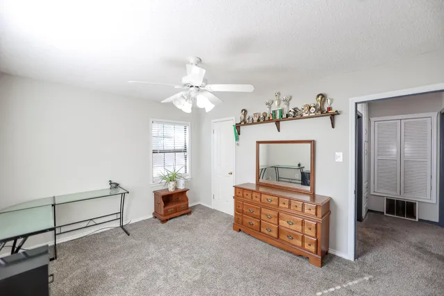 a living room with furniture and a mirror