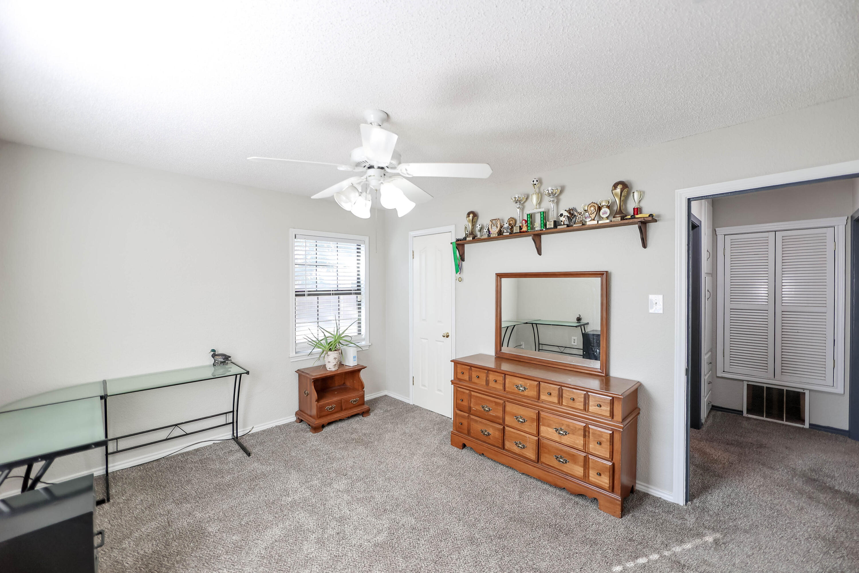 4607 33rd Street Lubbock, TX 79410 - Photo 12 of 22 a living room with furniture and a mirror