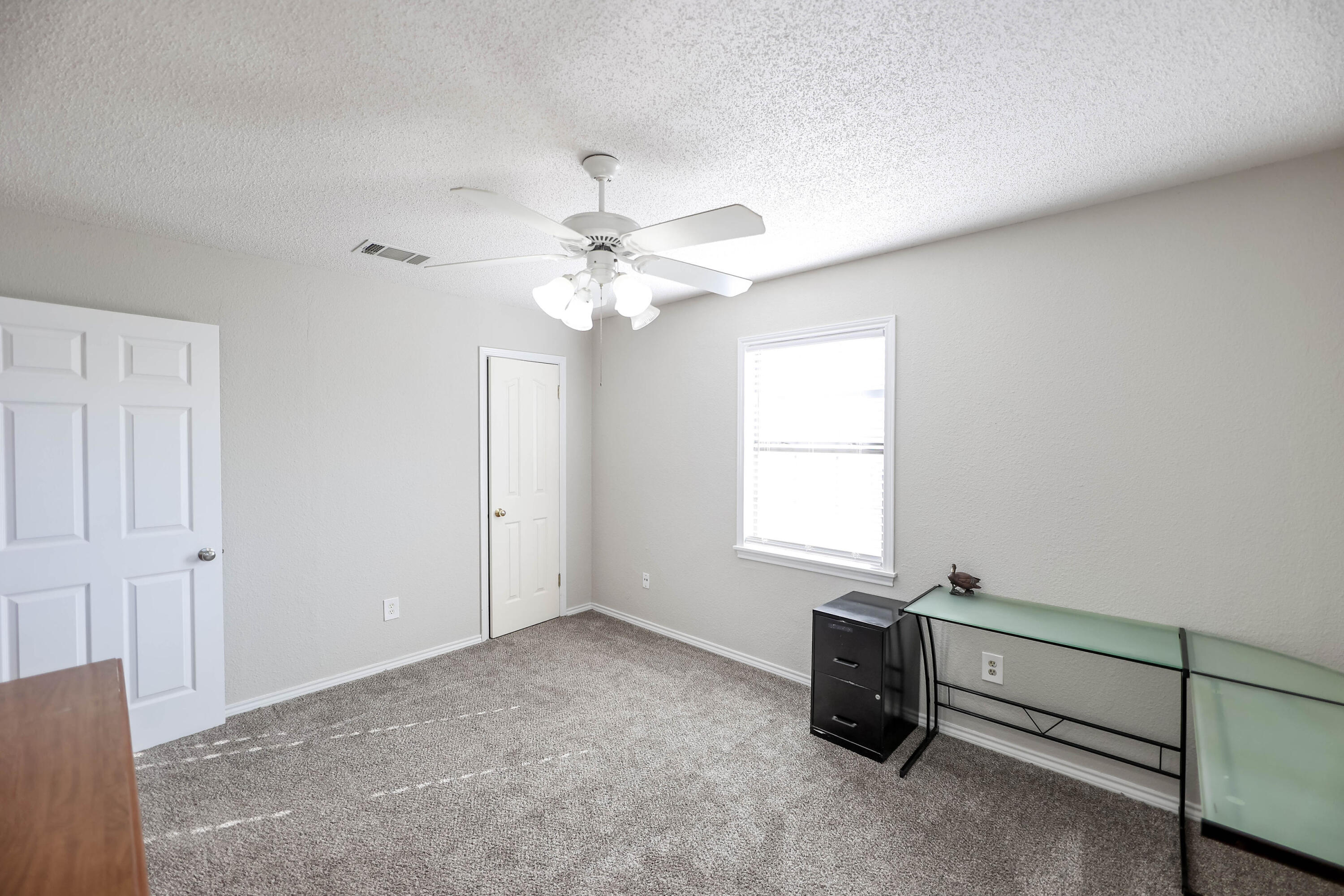 4607 33rd Street Lubbock, TX 79410 - Photo 13 of 22 an empty room with windows and fan