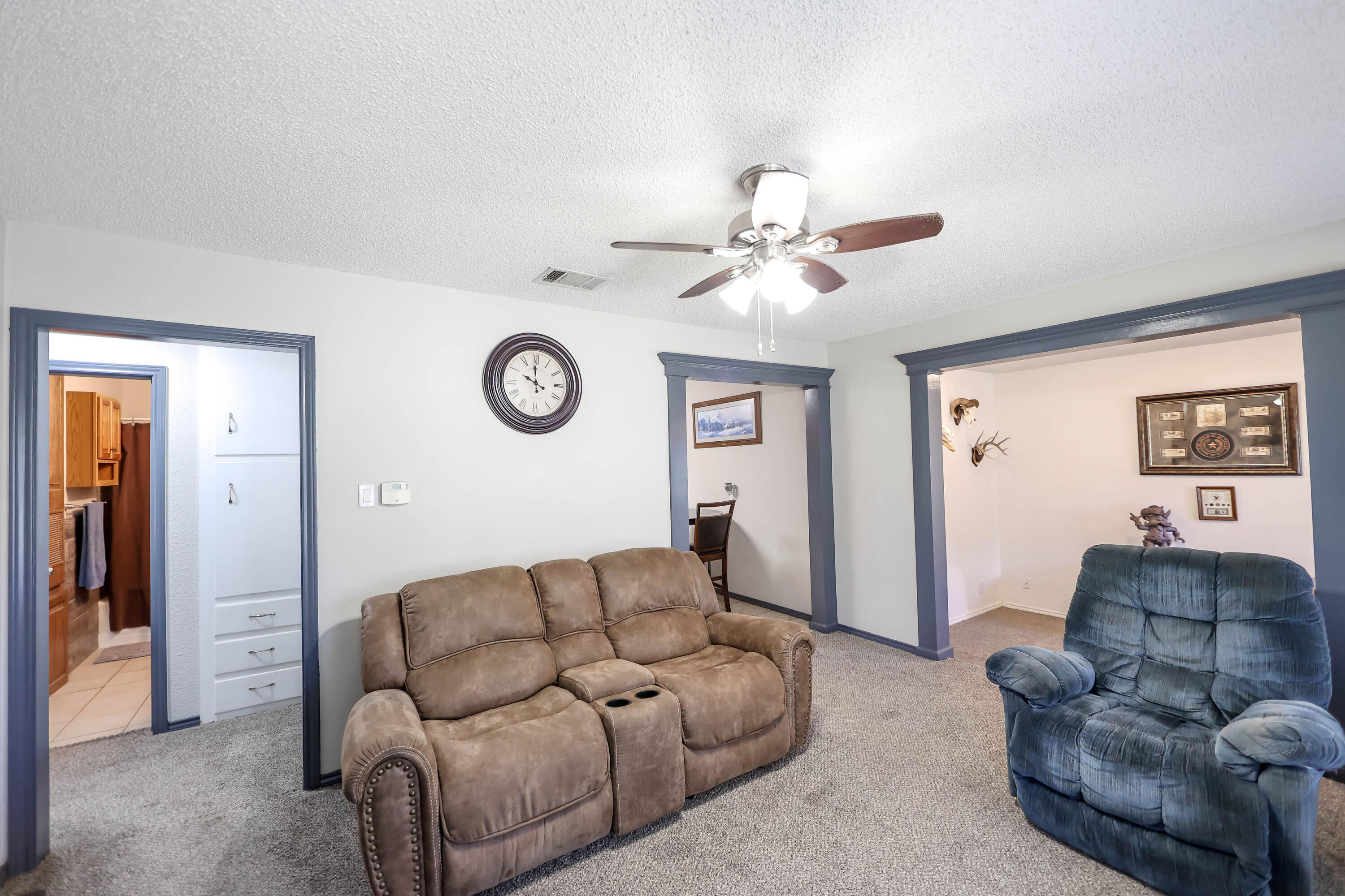 4607 33rd Street Lubbock, TX 79410 - Photo 3 of 22 a living room with furniture and a ceiling fan