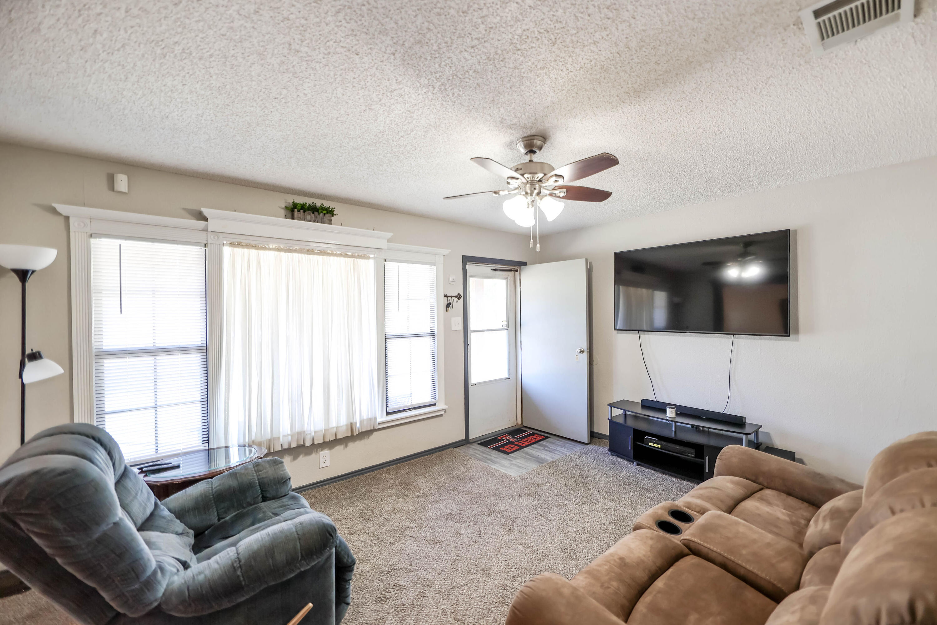 4607 33rd Street Lubbock, TX 79410 - Photo 4 of 22 a living room with furniture and a flat screen tv