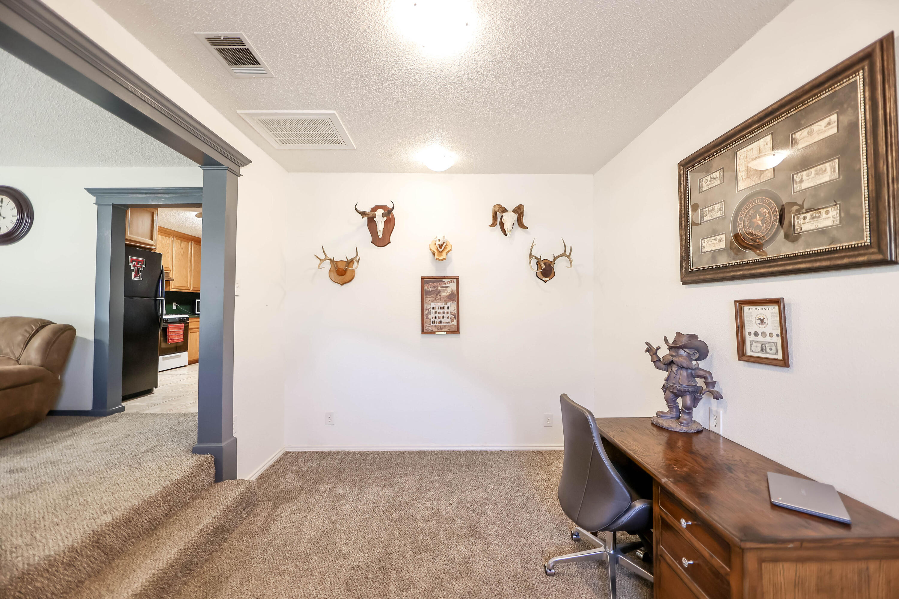 4607 33rd Street Lubbock, TX 79410 - Photo 5 of 22 a view of a workspace with furniture and a window
