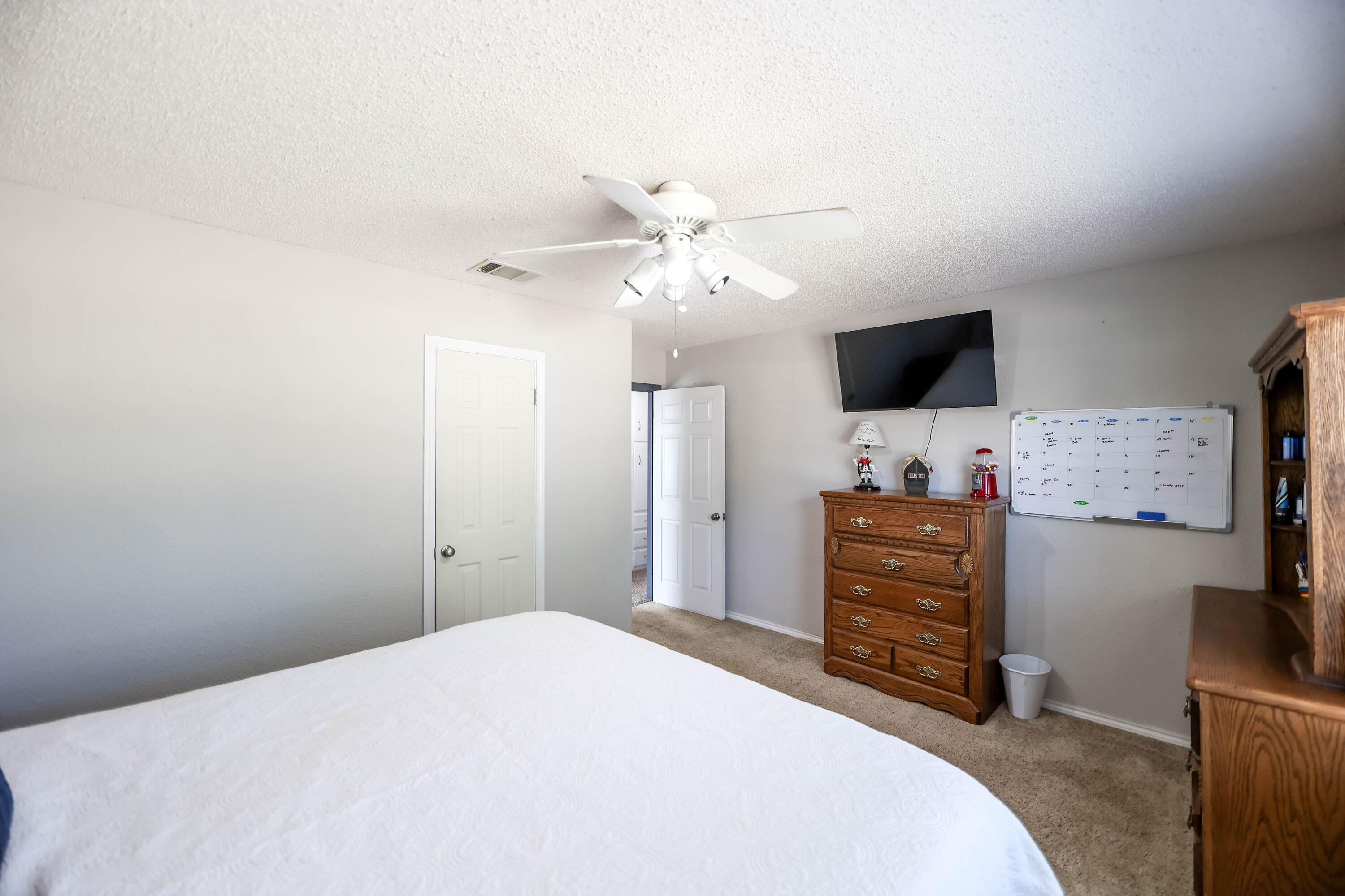 4607 33rd Street Lubbock, TX 79410 - Photo 9 of 22 a bedroom with a bed and a flat screen tv