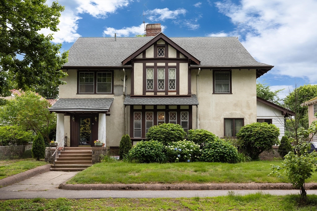 a front view of a house with garden