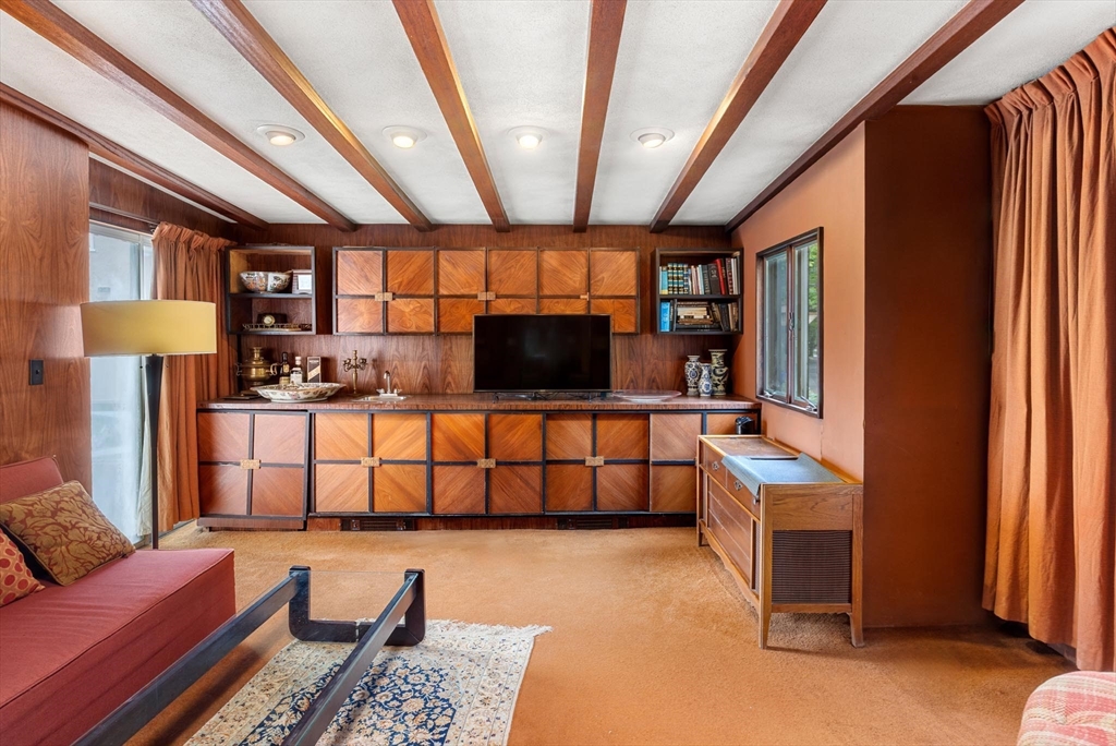 10 Evans Road Brookline, MA 02445 - Photo 4 of 10 a living room with furniture a flat screen tv and a table