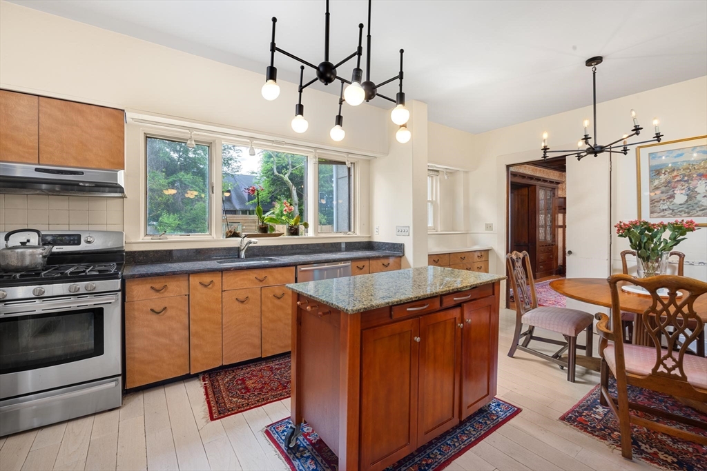10 Evans Road Brookline, MA 02445 - Photo 5 of 10 a kitchen with stainless steel appliances granite countertop a stove and a wooden floors
