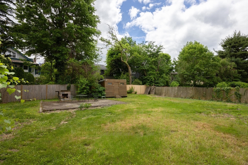 10 Evans Road Brookline, MA 02445 - Photo 8 of 10 a backyard of a house with trees and wooden fence