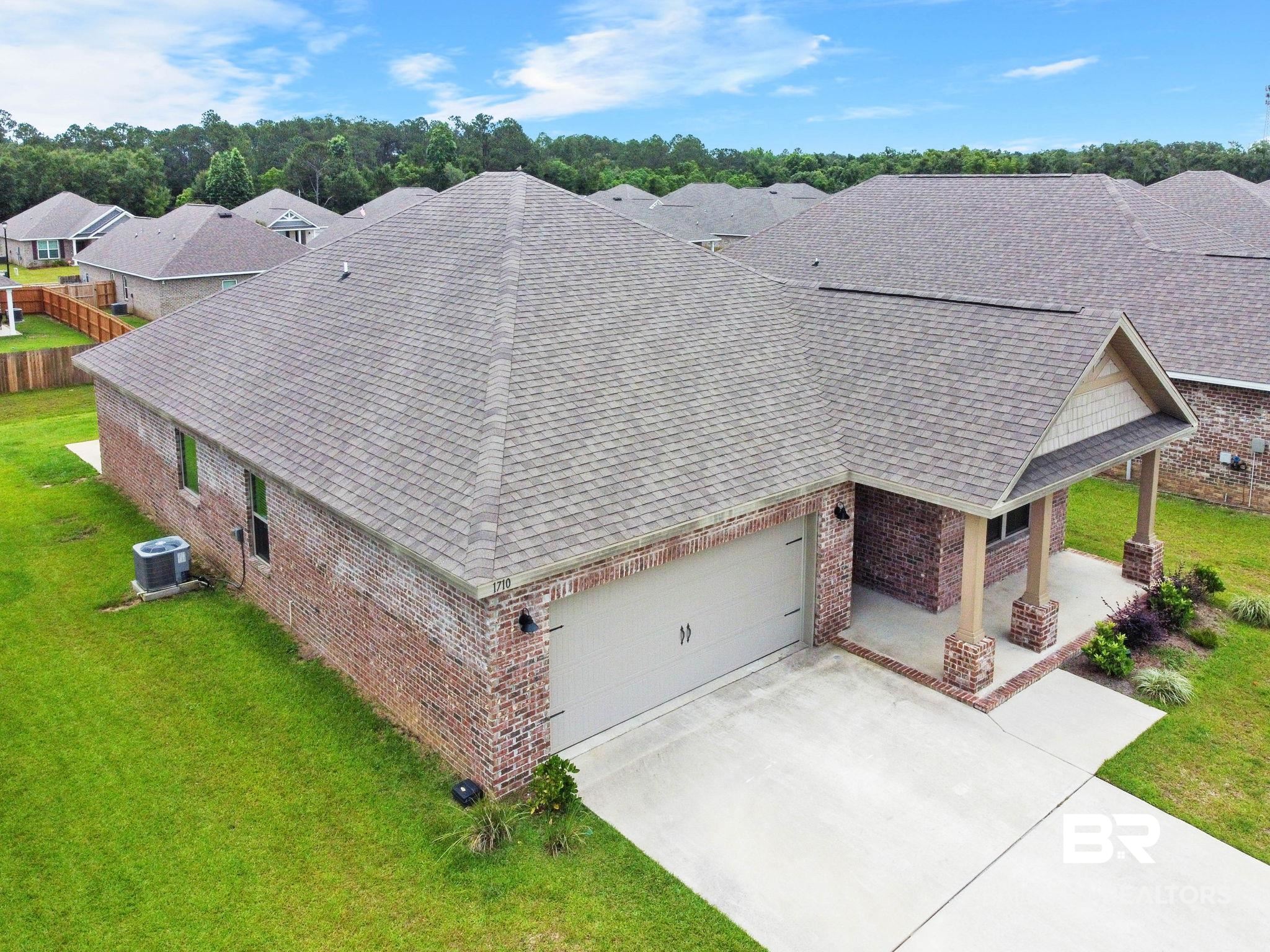 1710 Grouse Street Foley, AL 36535 - Photo 7 of 76 Brick exterior with a covered porch, two-car garage, and shingled roof