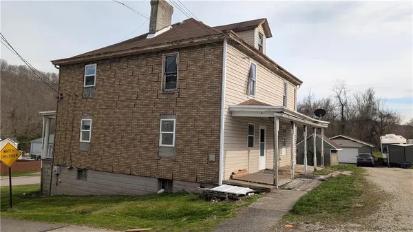a front view of a house with a yard