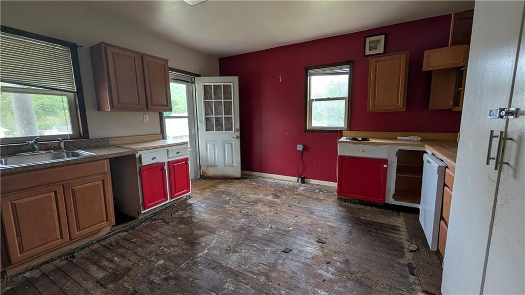 102 Moose Hill Road Millsboro, PA 15348 - Photo 10 of 11 a kitchen with stainless steel appliances granite countertop a stove sink and cabinets