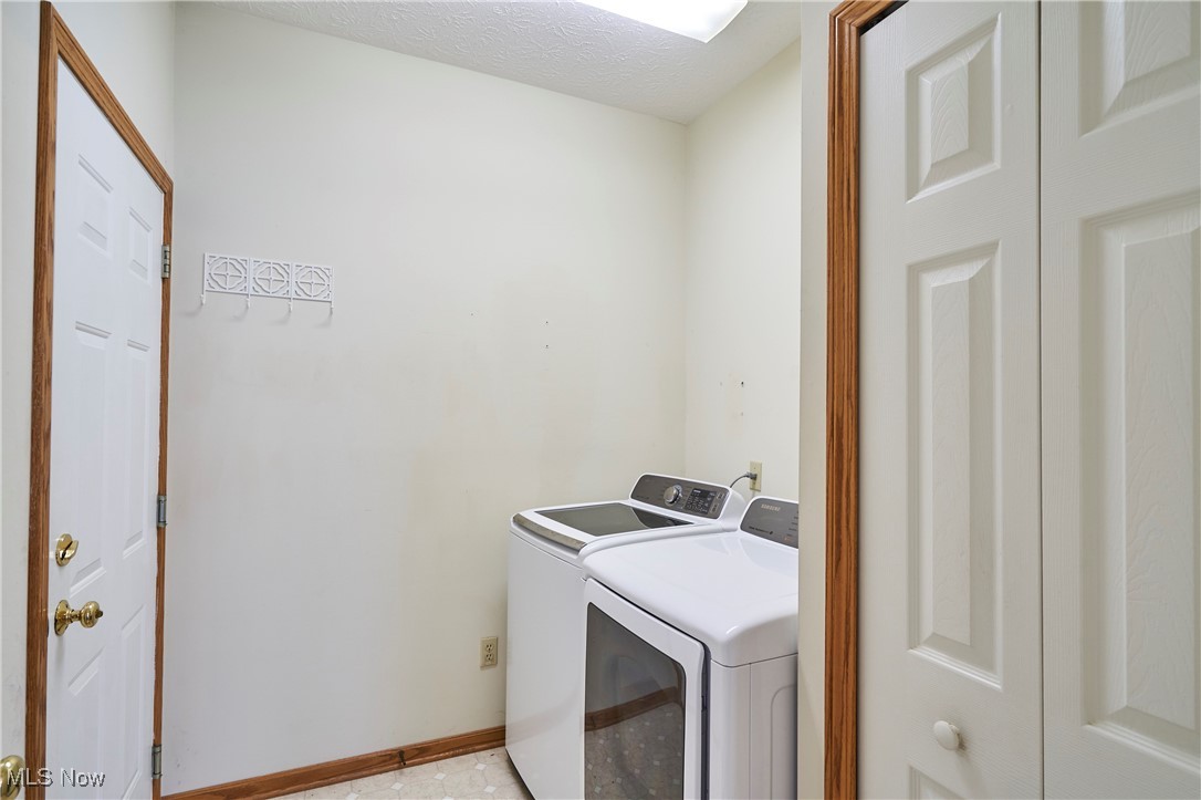 637 Redfield Lane Akron, OH 44321 - Photo 14 of 31 First floor laundry with washer and dryer and a double closet-