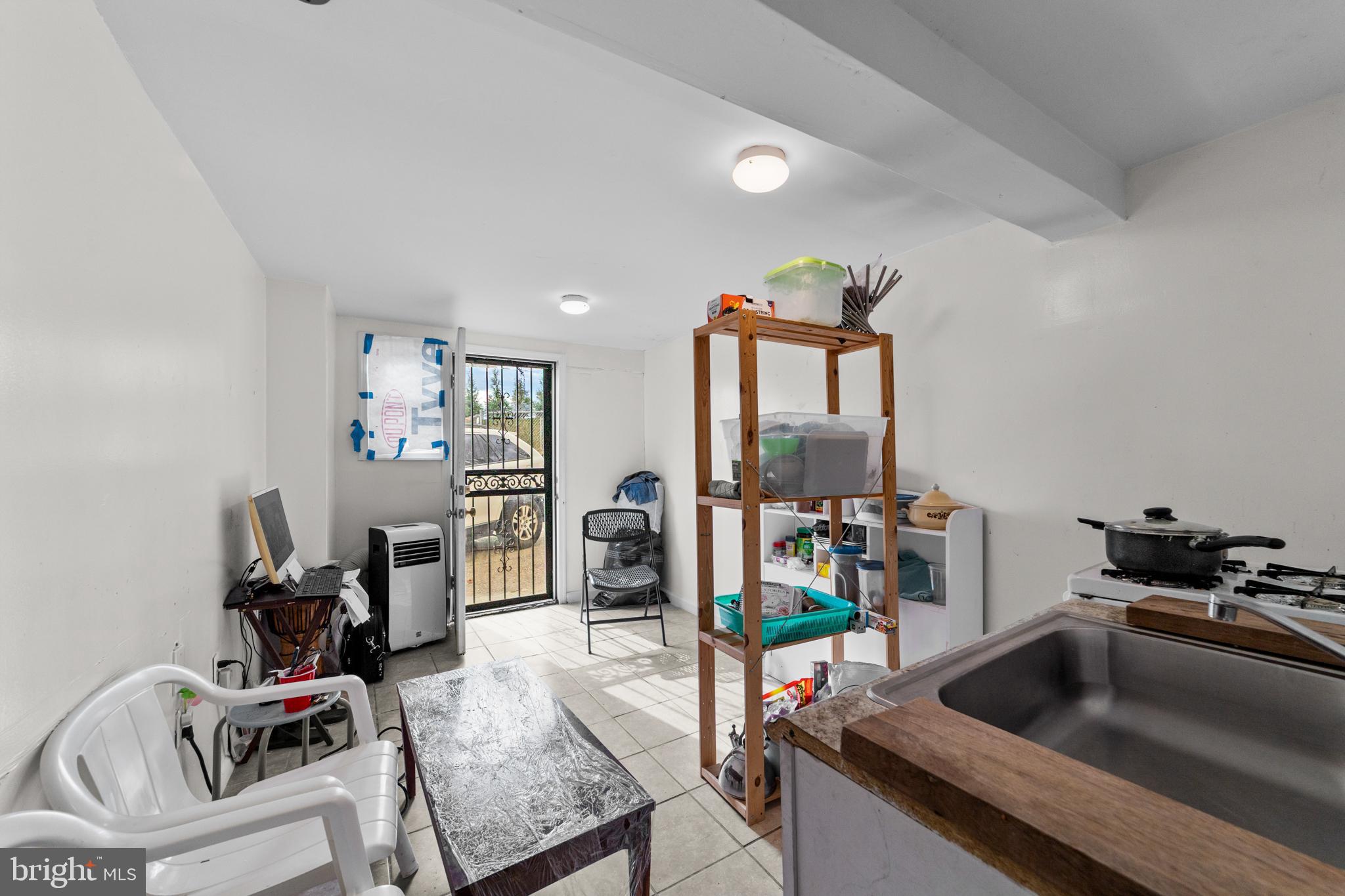 1314 Farrington Road Philadelphia, PA 19151 - Photo 18 of 21 a living room with furniture and flat screen tv