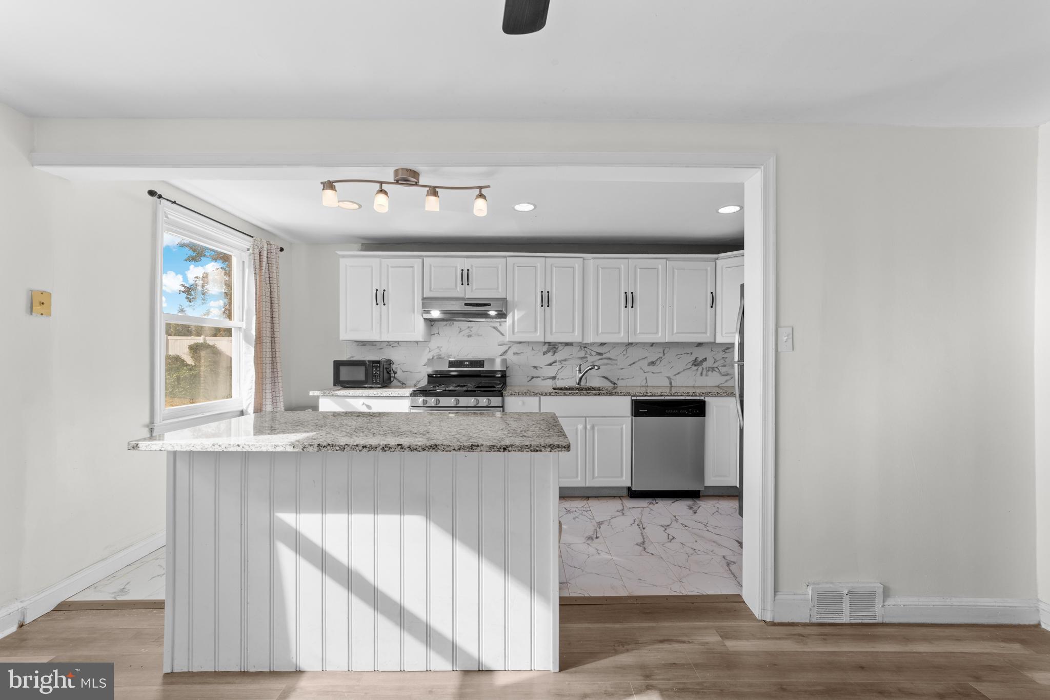 1314 Farrington Road Philadelphia, PA 19151 - Photo 7 of 21 a kitchen with stainless steel appliances granite countertop a sink and cabinets